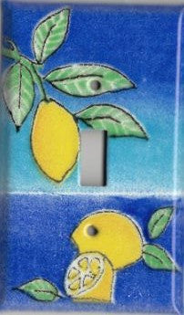 A handmade single toggle fused glass switch plate cover with the image of lemons.